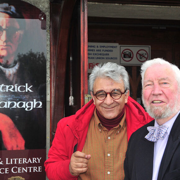 Photo of Rafiq Kathwari in front of Patrick Kavanagh poster