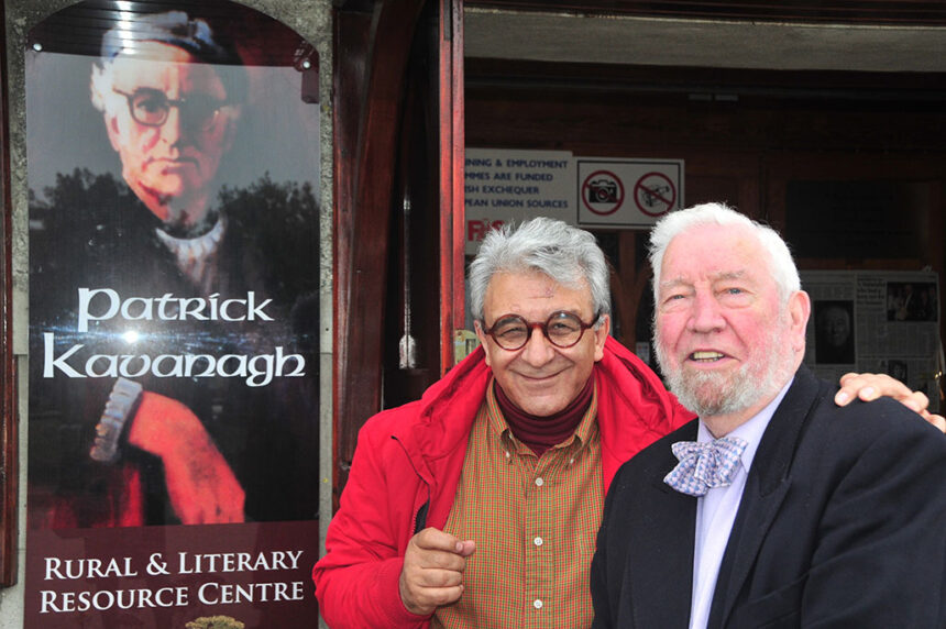 Photo of Rafiq Kathwari in front of Patrick Kavanagh poster