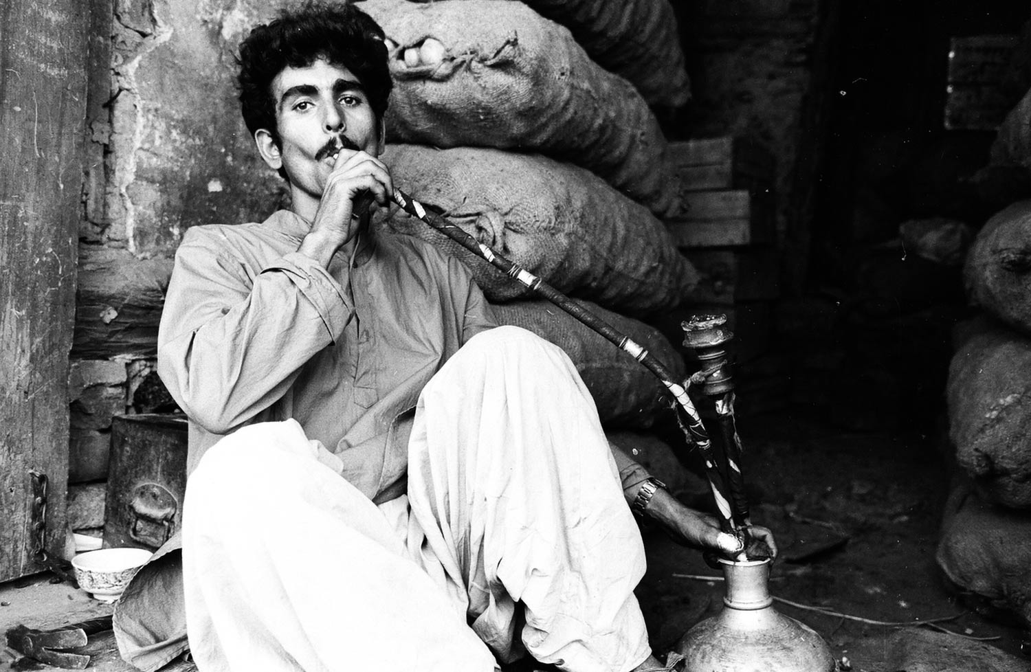 Photo by Rafiq Kathwari: Man smokes hookah