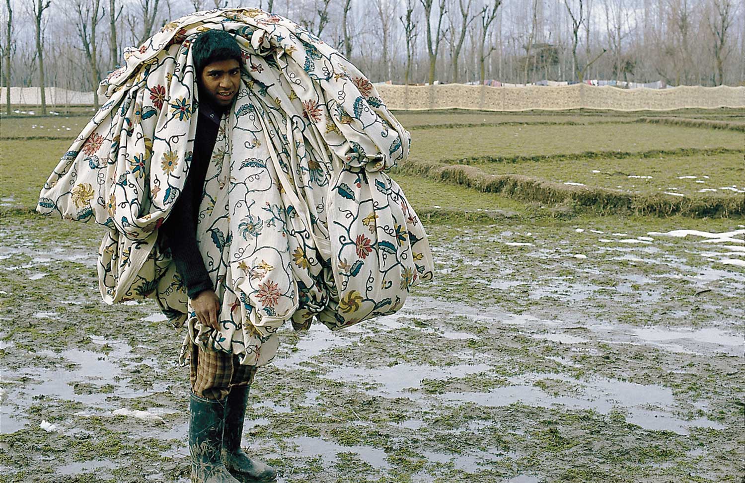 Photo by Rafiq Kathwari: Young man carries completed Kashmir crewel